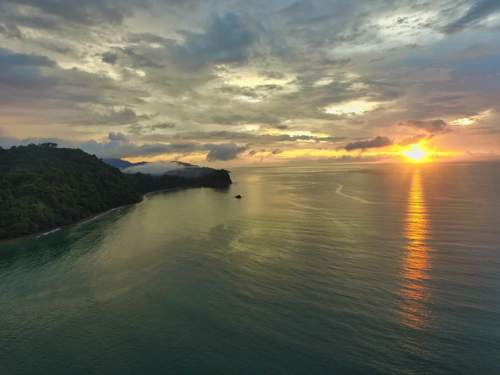 Golden sunset over the remote rainforest bay of Drake Bay on the Osa Peninsula
