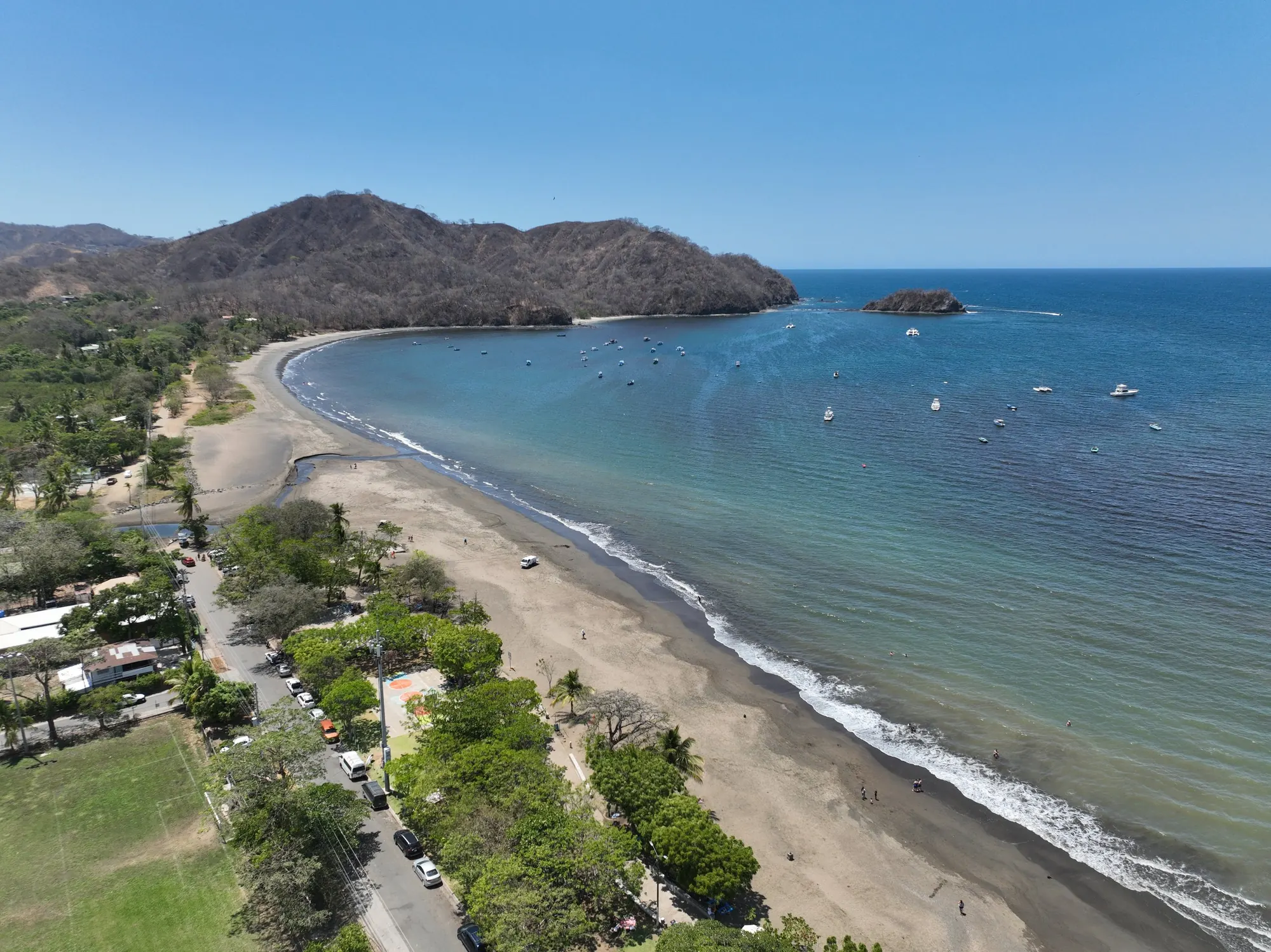 Aerial view of Playas del Coco bay, turquoise Pacific water, and volcanic headlands in Guanacaste, Costa Rica