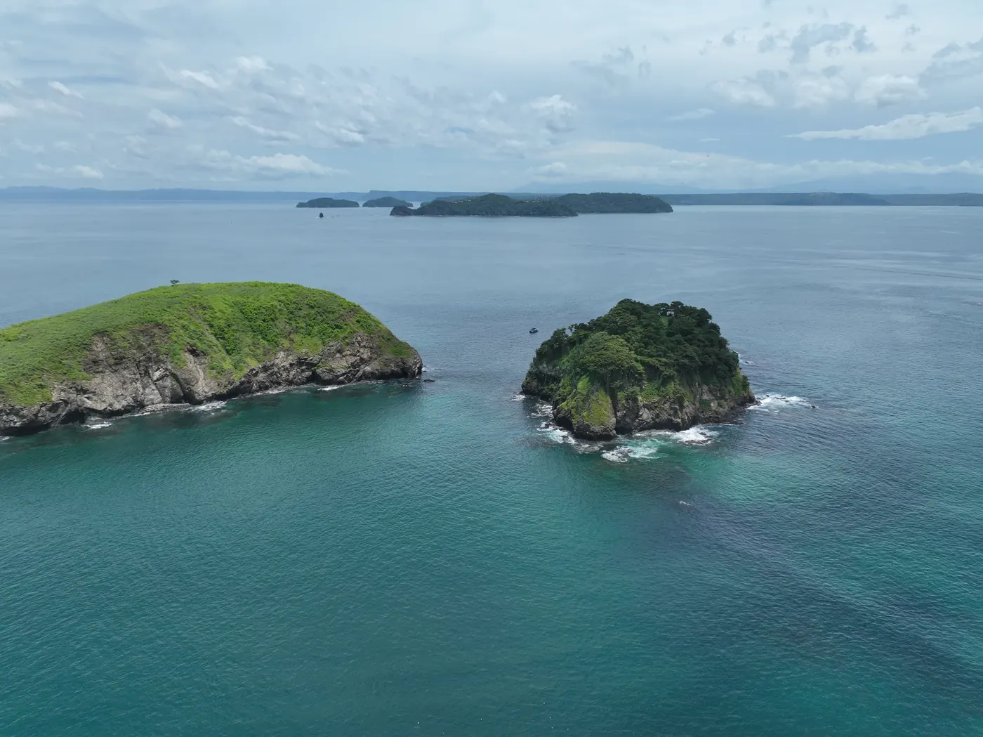 Clear turquoise waters surrounding volcanic islets off the Pacific coast of Costa Rica